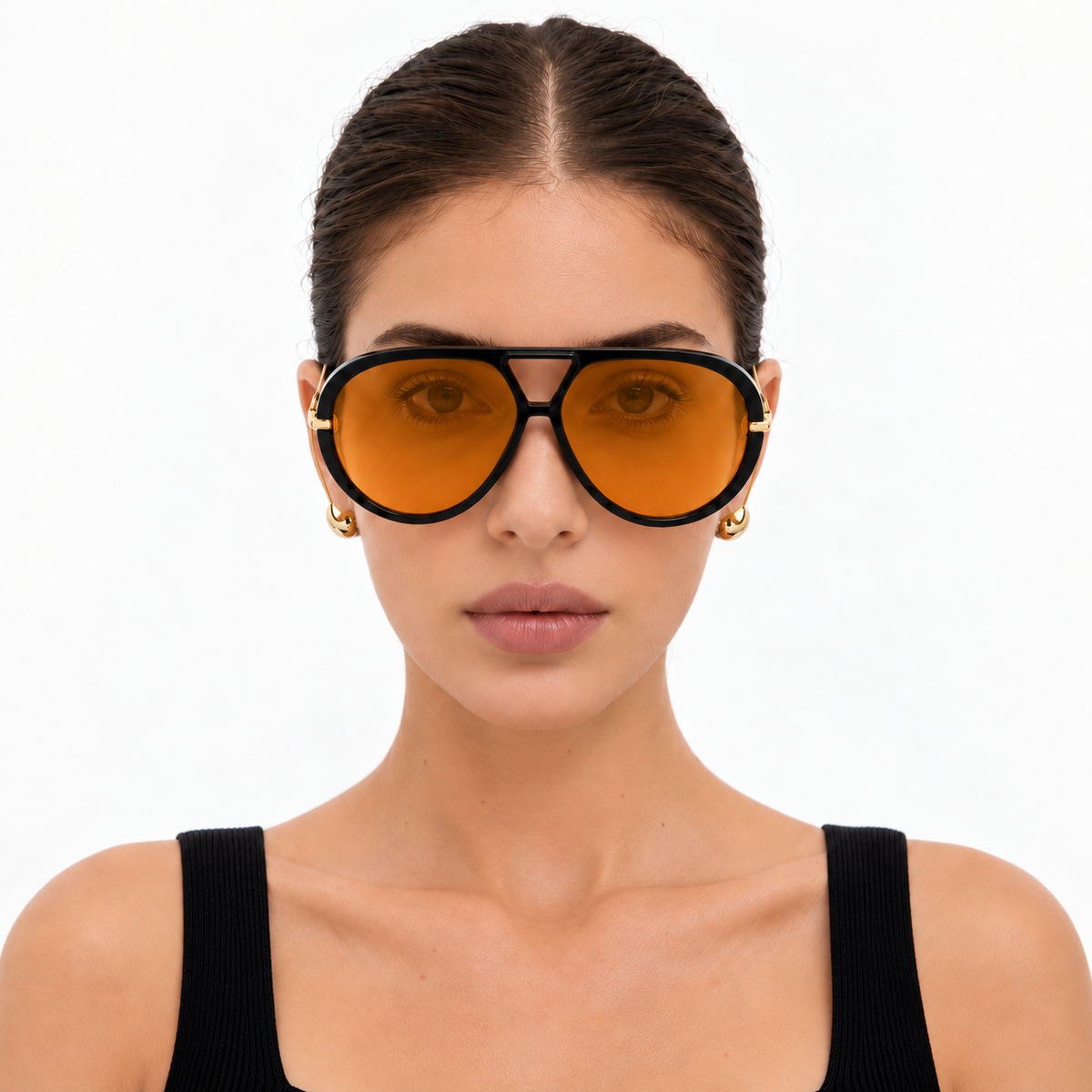 Model wearing The Nimbus oversized black aviator sunglasses with orange tinted lenses and gold drop temples, studio portrait — Velezeco #opt1_3