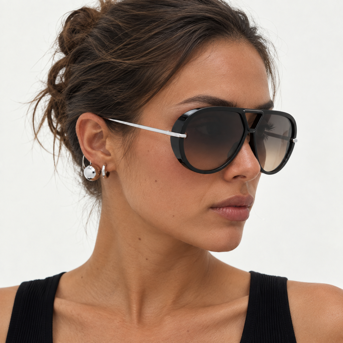 Woman in a black top wearing The Nimbus oversized black aviator sunglasses with gradient lenses and silver drop temples, studio portrait — Velezeco #opt1_2