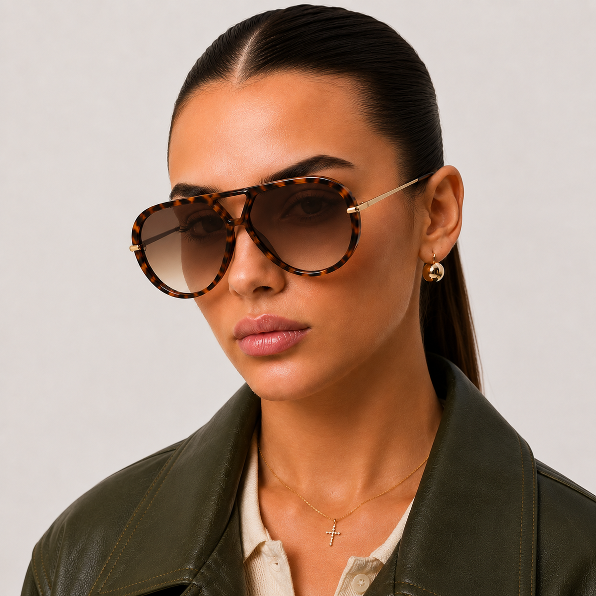 Woman wearing The Nimbus oversized tortoiseshell aviator sunglasses with brown gradient lenses and gold metal temples by Velezeco. #opt1_4