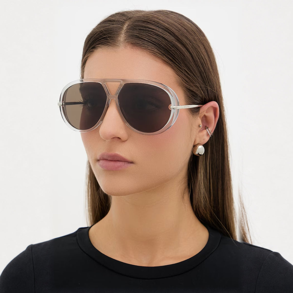 Model wearing The Nimbus white oversized aviator sunglasses with gold drop temples, studio portrait — Velezeco #opt1_6