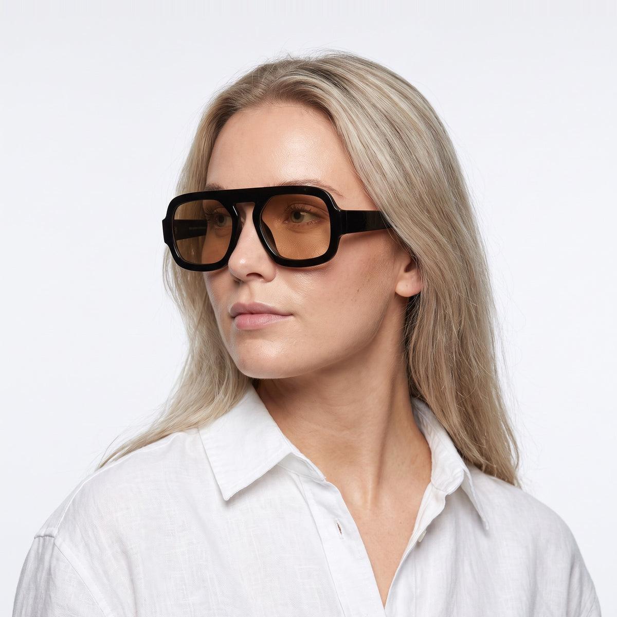 Woman in a white linen shirt wearing Vortex black square pilot sunglasses with champagne lenses · Velezeco #opt1_8