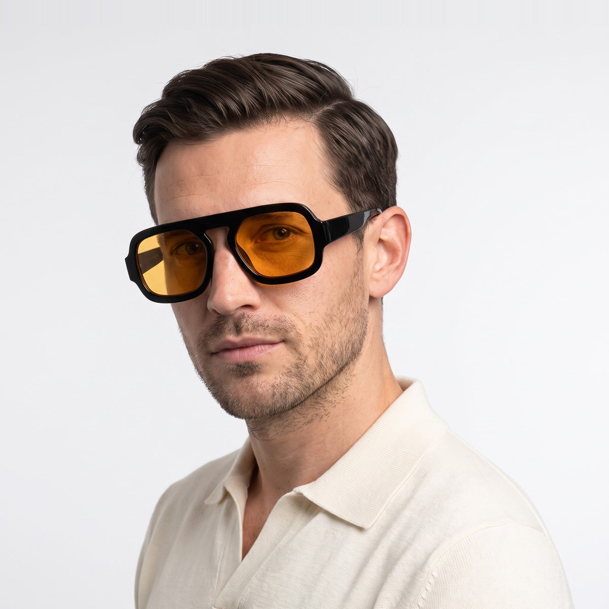 Man in a cream knit polo wearing Vortex black square pilot sunglasses with amber yellow lenses · Velezeco #opt1_5