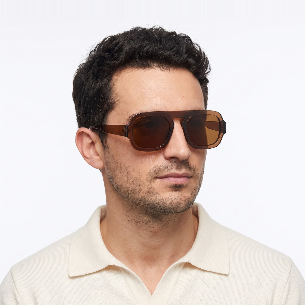 Man in a cream knit polo wearing Vortex translucent brown square pilot sunglasses with brown lenses · Velezeco #opt1_6