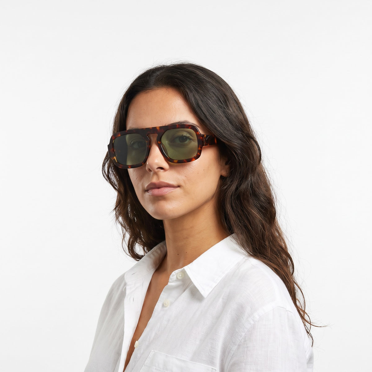 Woman in a white linen shirt wearing Vortex leopard square pilot sunglasses with green lenses · Velezeco #opt1_1